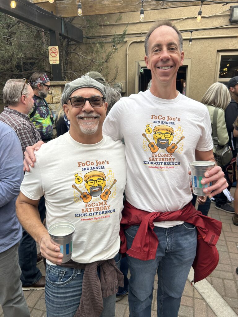 Joe, at left, and Chris smiling together in FoCo Joe’s brunch shirts